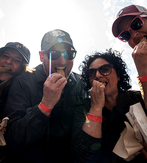 a group of people eating churros
