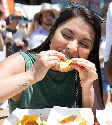 photo of woman eating a taco
