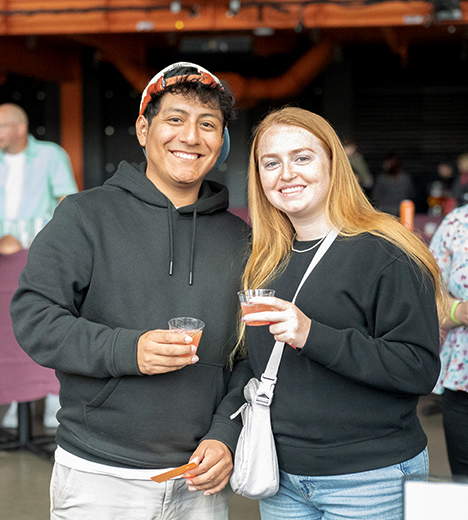 a couple holding margaritas in the Musikfest Cafe