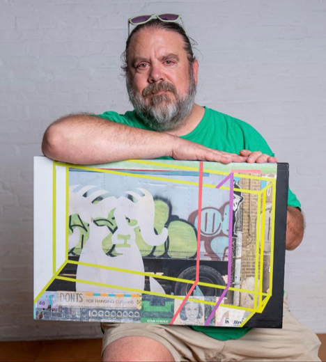 Danny Moyer holding artwork
