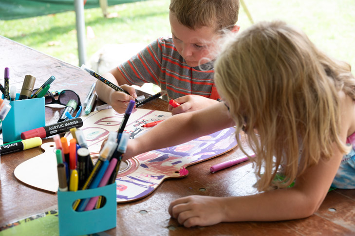 Children working on an art project at the Crayola Creativity Tent