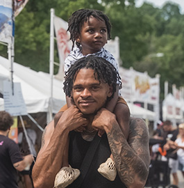 Man at Musikfest with child on shoulders
